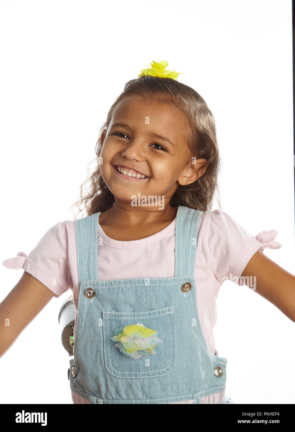 little girl in overalls Stock Photo