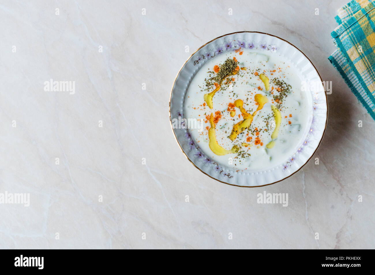 Cacik / Tzatziki Sauce with Yogurt, Cucumber Slices, Olive Oil, Thyme and Red Pepper Powder in Ceramic Bowl. Traditional Organic Food. Stock Photo