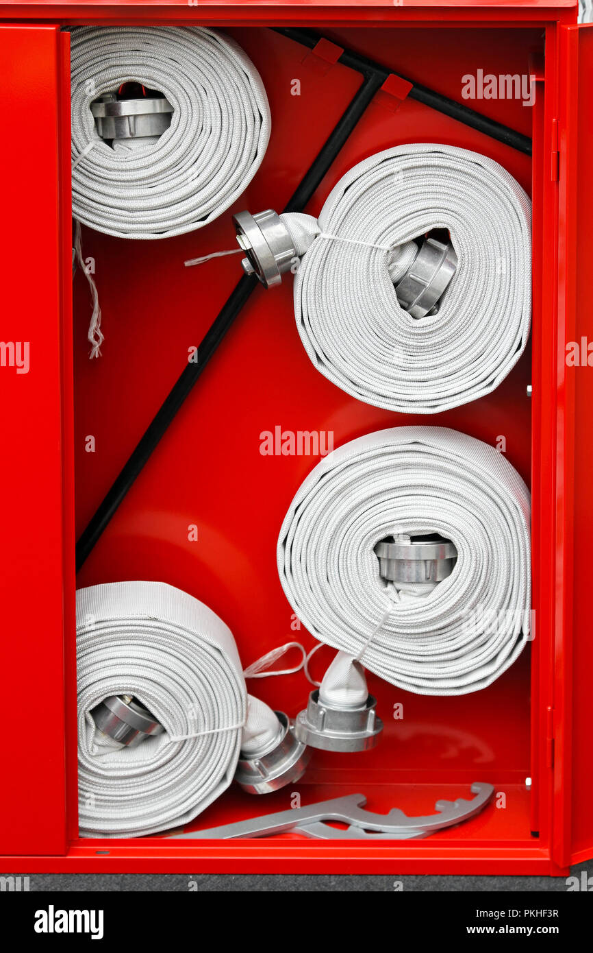 https://c8.alamy.com/comp/PKHF3R/fire-hoses-packed-inside-of-red-emergency-box-PKHF3R.jpg