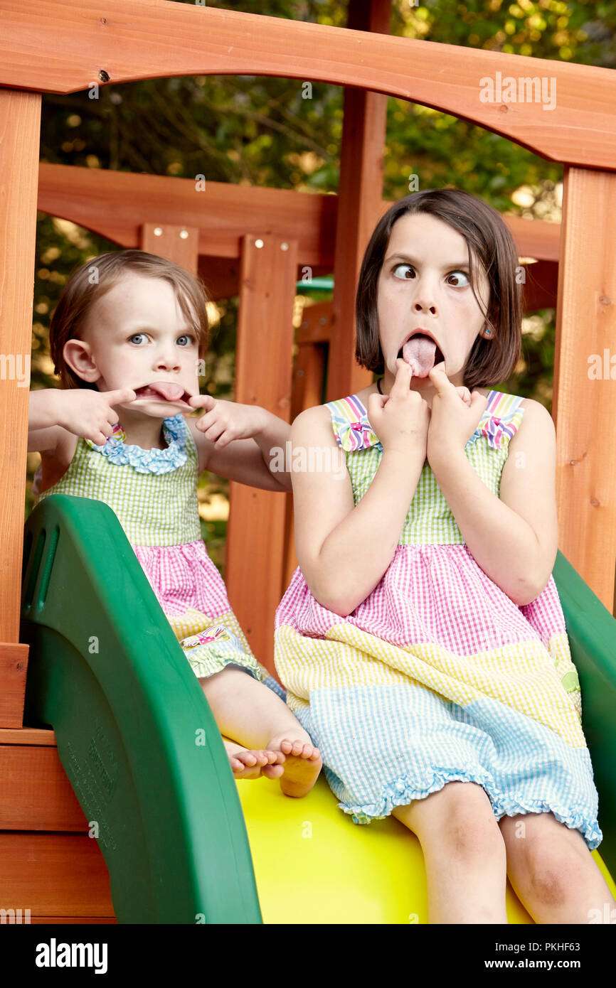 little girl playing and making funny faces Stock Photo