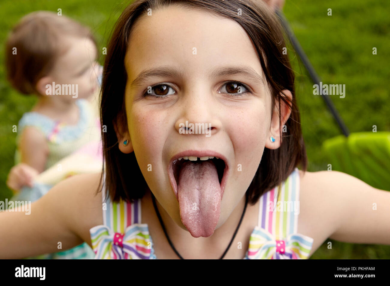 little girl playing and making funny faces Stock Photo - Alamy