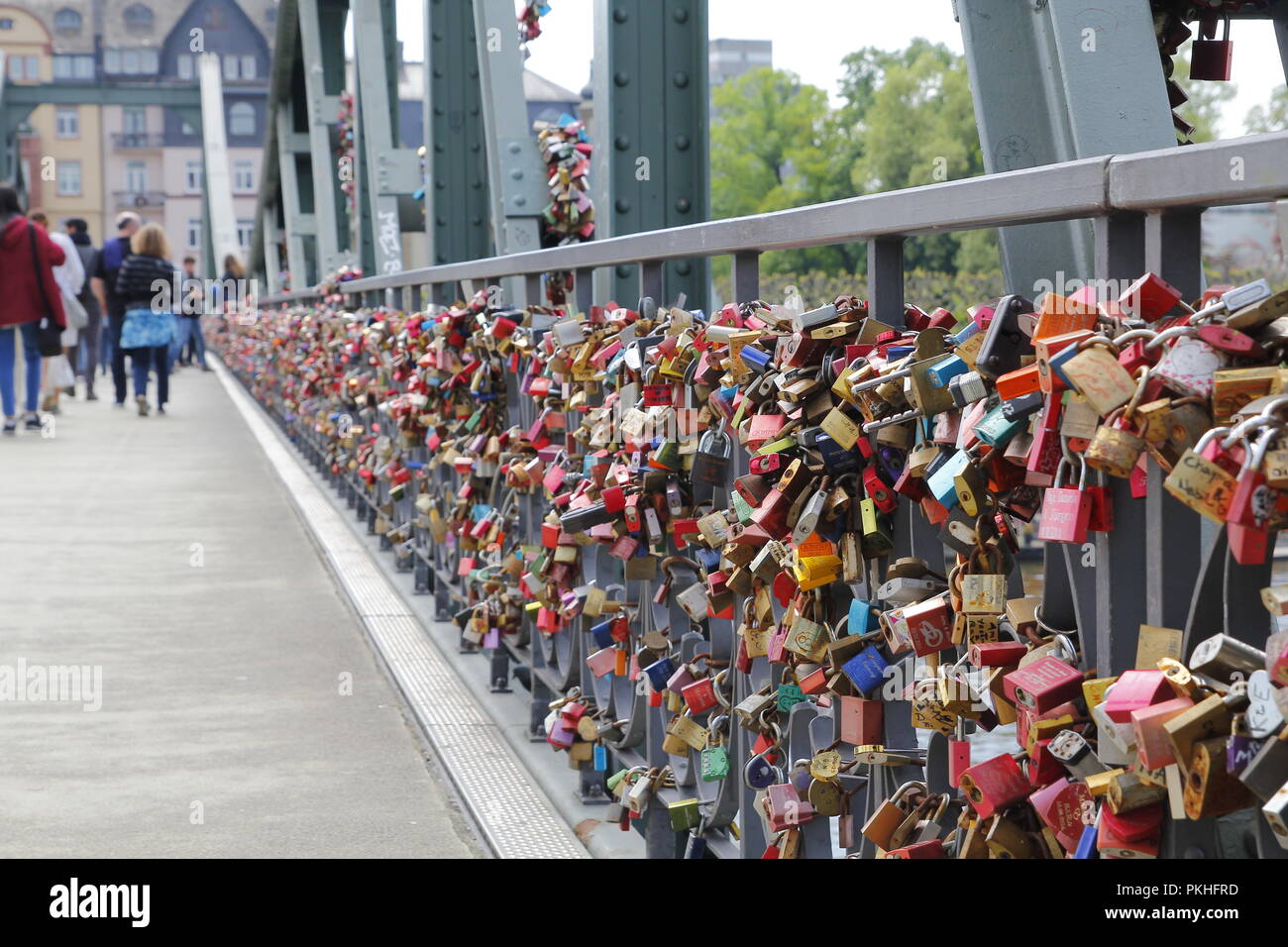 Lots of padlocks locked in a bridge over river Main, Frankfurt, Germany Stock Photo