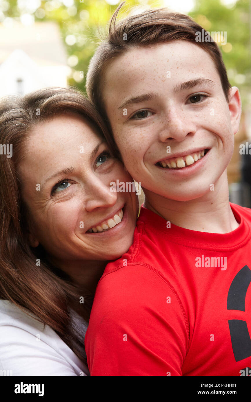 son sitting on mothers lap smiling Stock Photo