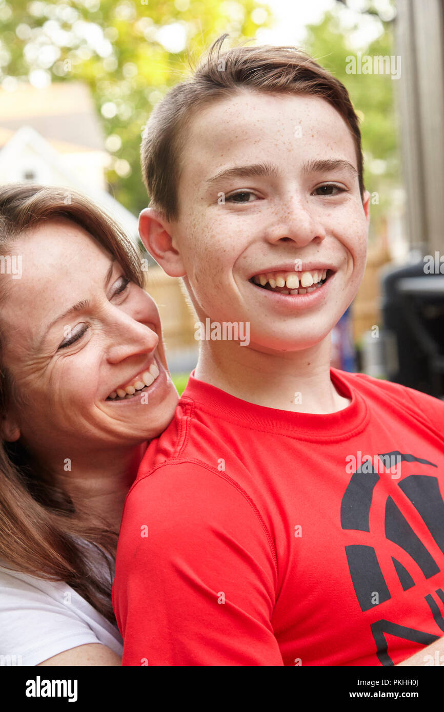 son sitting on mothers lap smiling Stock Photo