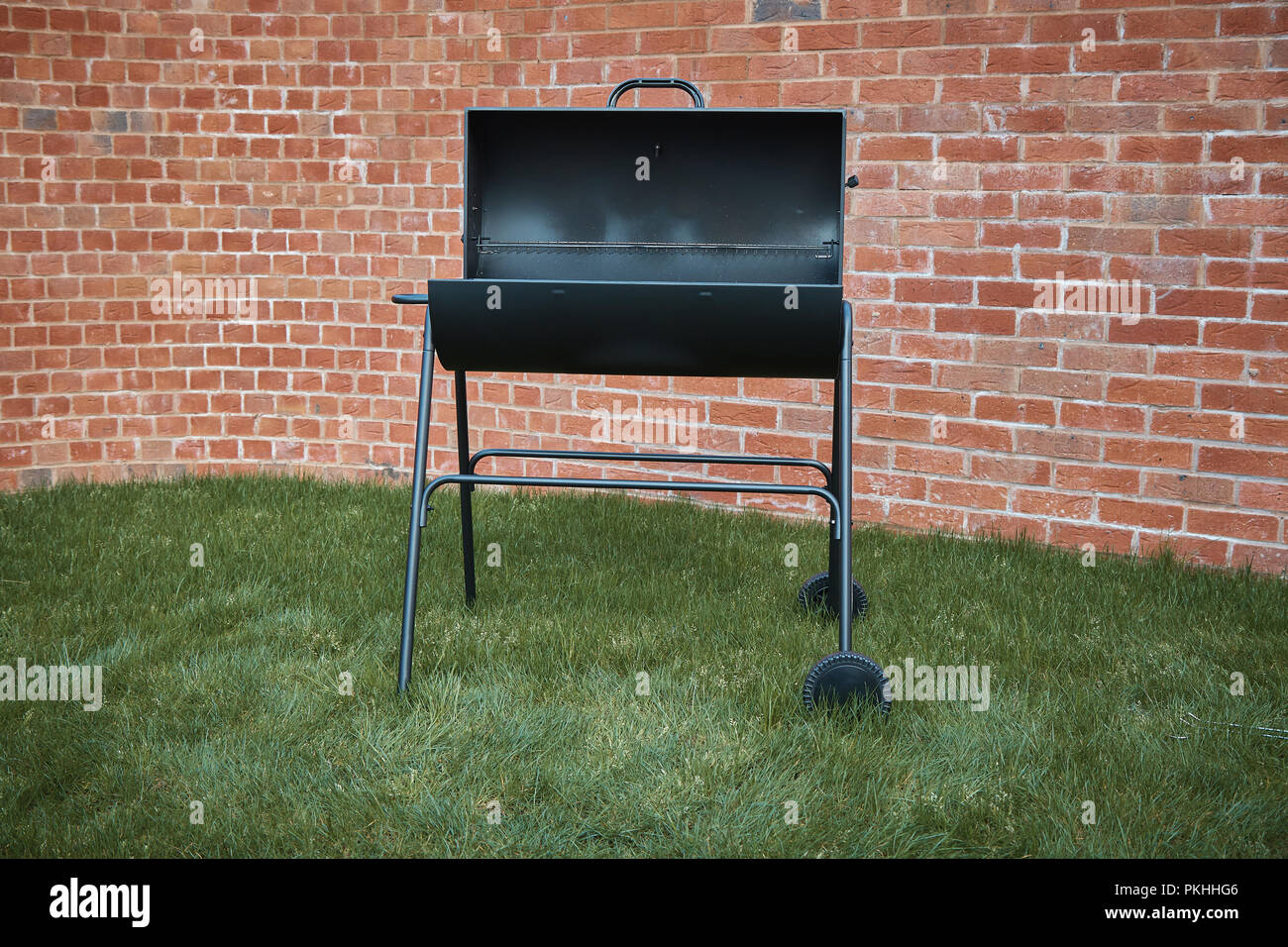 Black big barrel grill in the garden Stock Photo Alamy