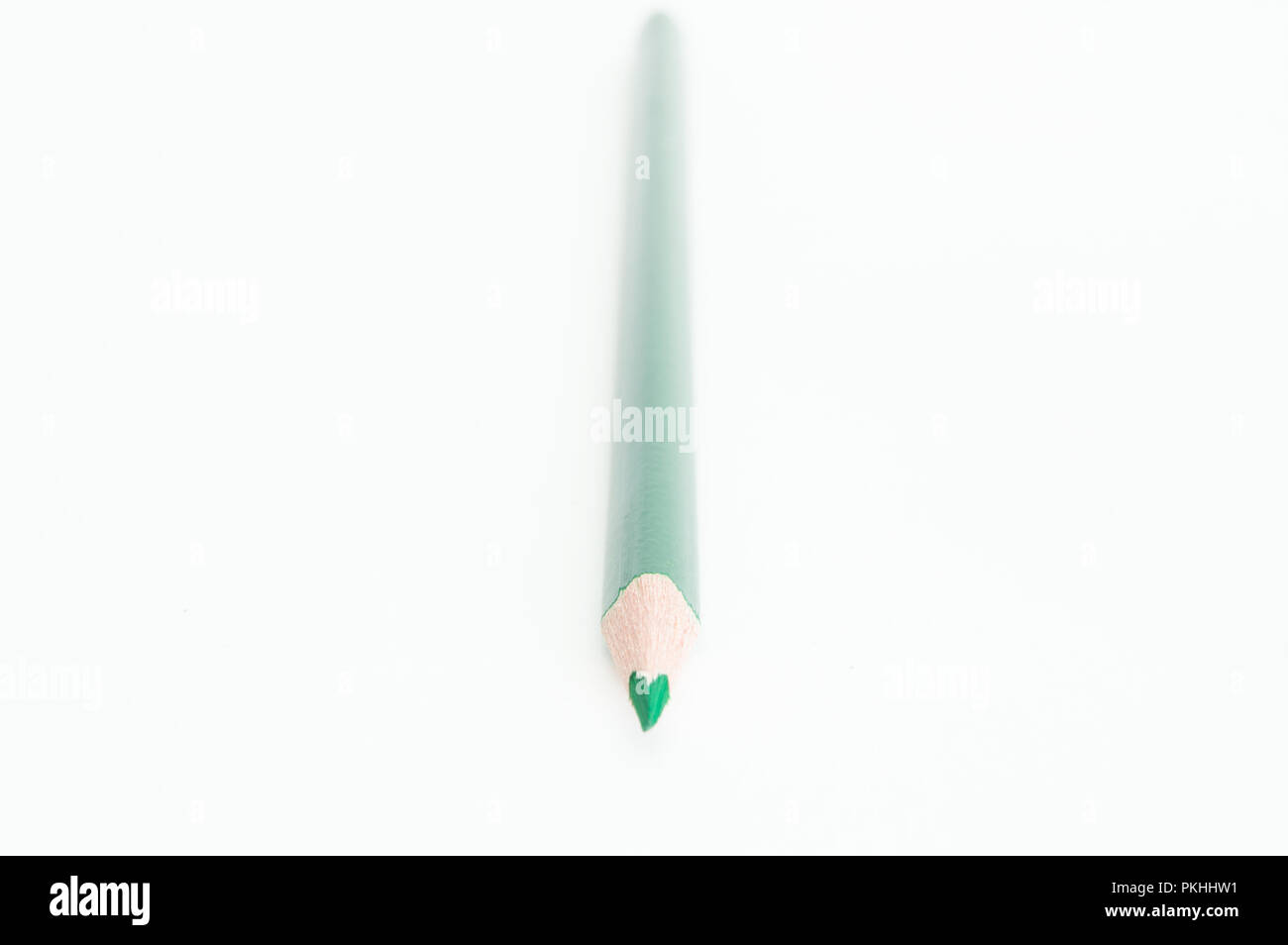 An isolated green colored pencil on a white background. Stock Photo