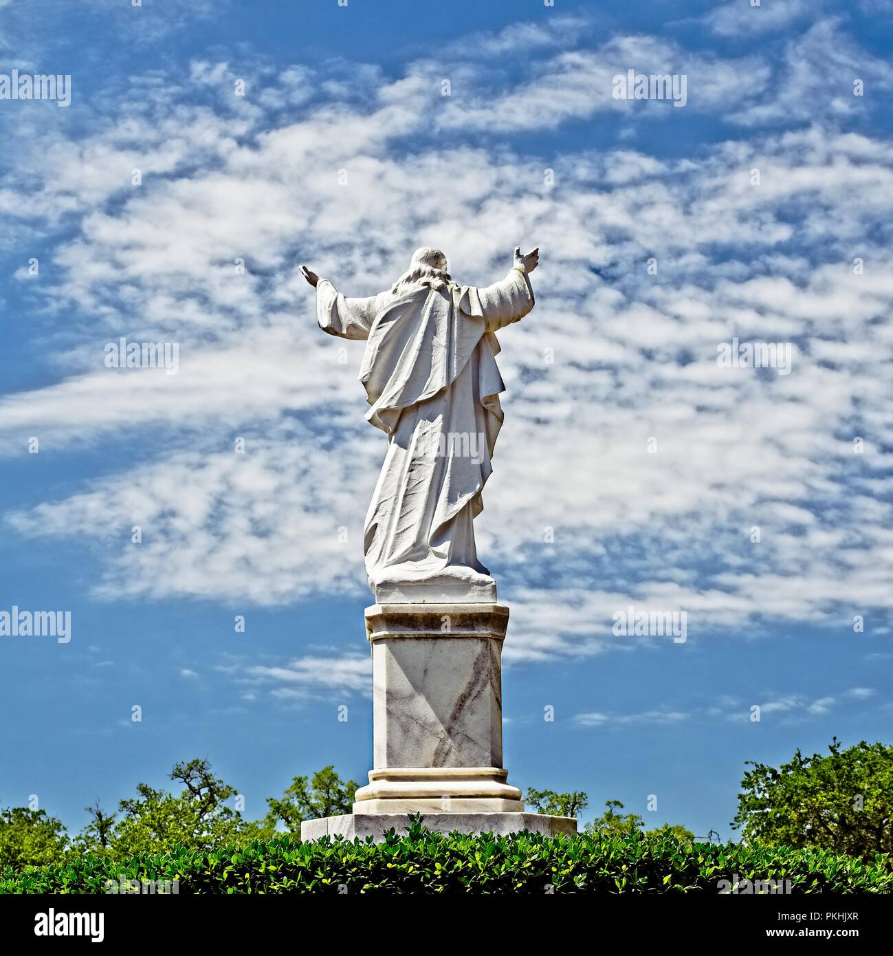 New Orleans, LA USA - May 9, 2018  -  Statue of Jesus with Hands Raised at Loyola University Stock Photo