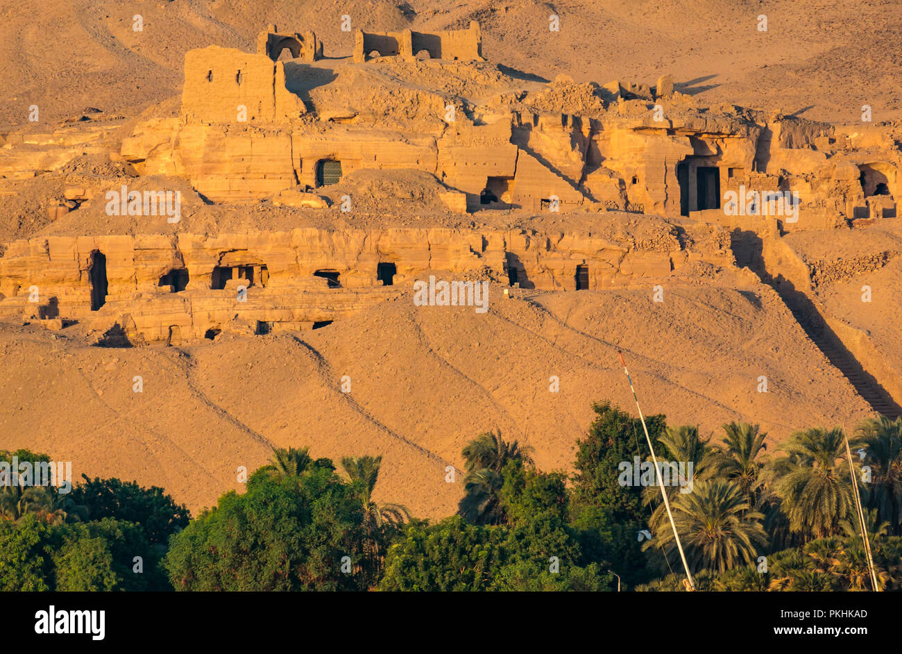 Rock cut ancient tombs of high-status officials of Old and Middle Kingdom in desert cliff, Qubbet el Hawa, Nile River, Aswan, Egypt, Africa Stock Photo