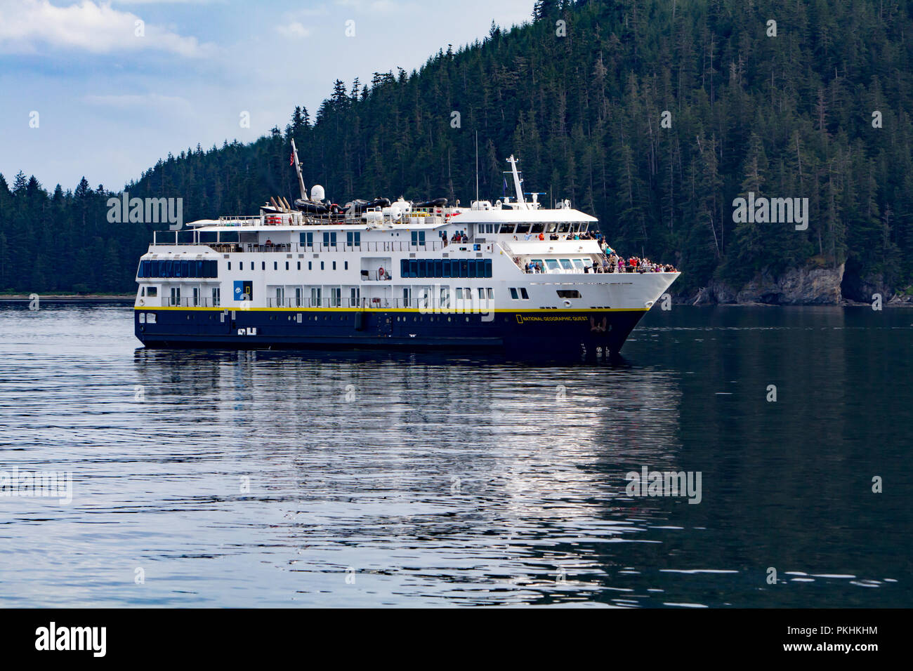 The expedition cruise ship, the National Geographic Quest sails in Chatham Strait in Southeast Alaska filled with ecotourists to look for whales. Stock Photo