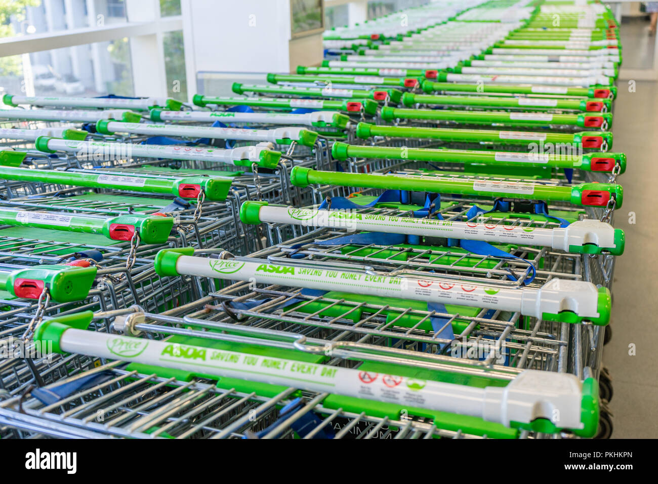 Rows of shopping trolleys at an Asda supermarket in England, UK Stock