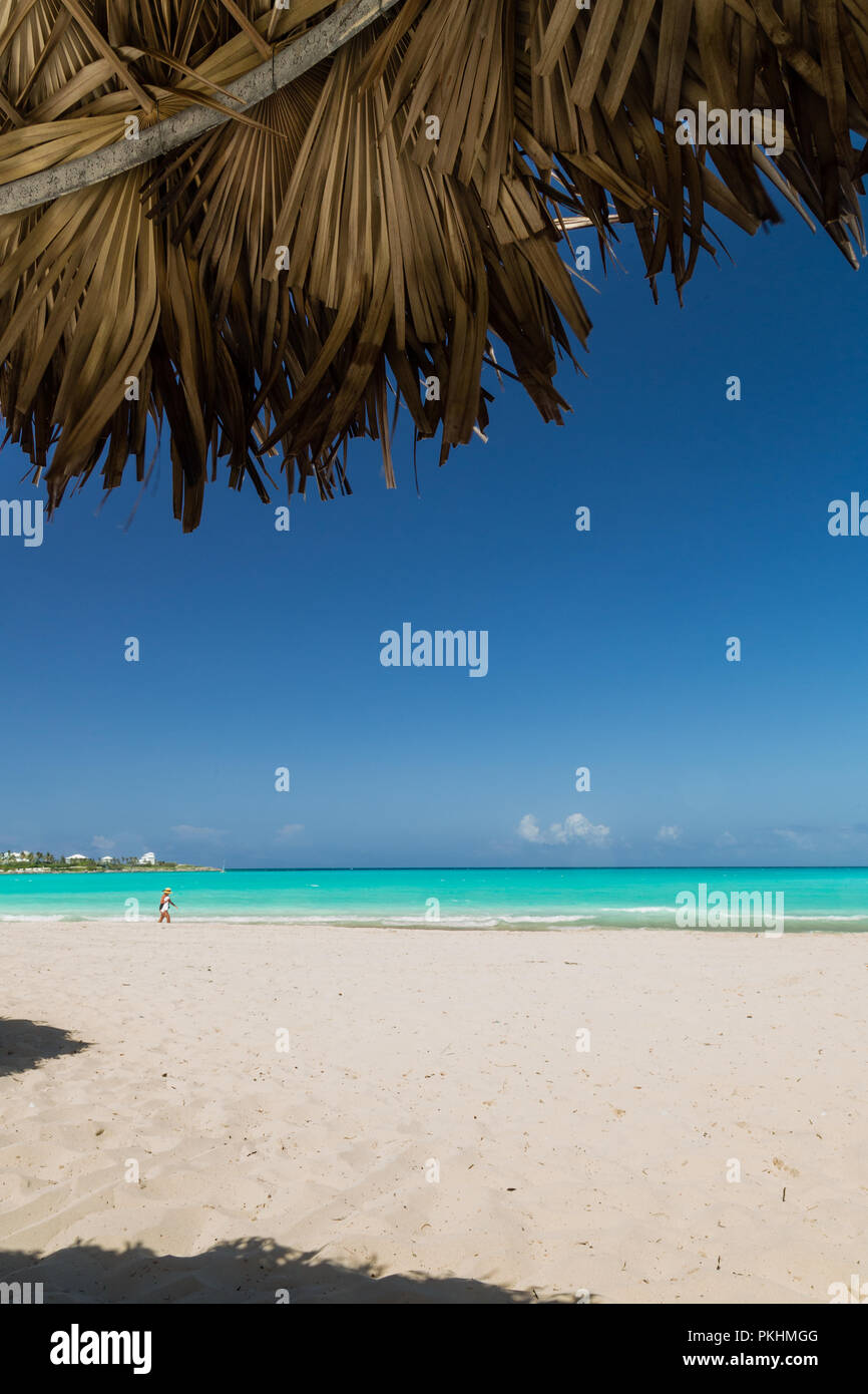 Exuma, Bahamas beach scene looking out palapa blue ocean sky Stock Photo