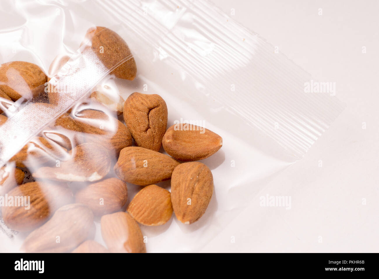 almonds packages in plastic packaging isoalted on white background Stock Photo