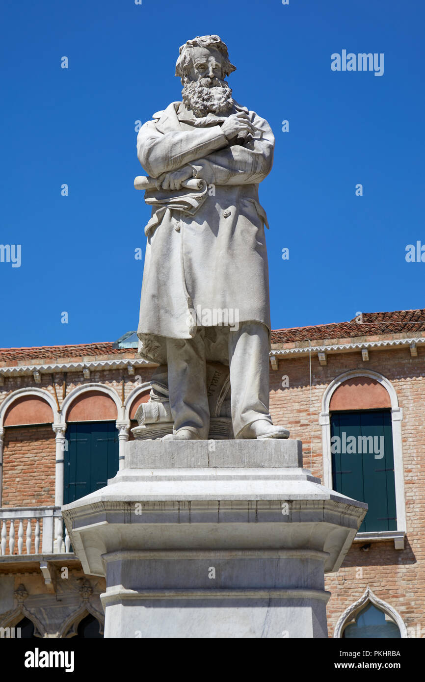 Niccolo Tommaseo statue in Venice by Francesco Barzaghi (1839-1892), clear blue sky in Italy Stock Photo