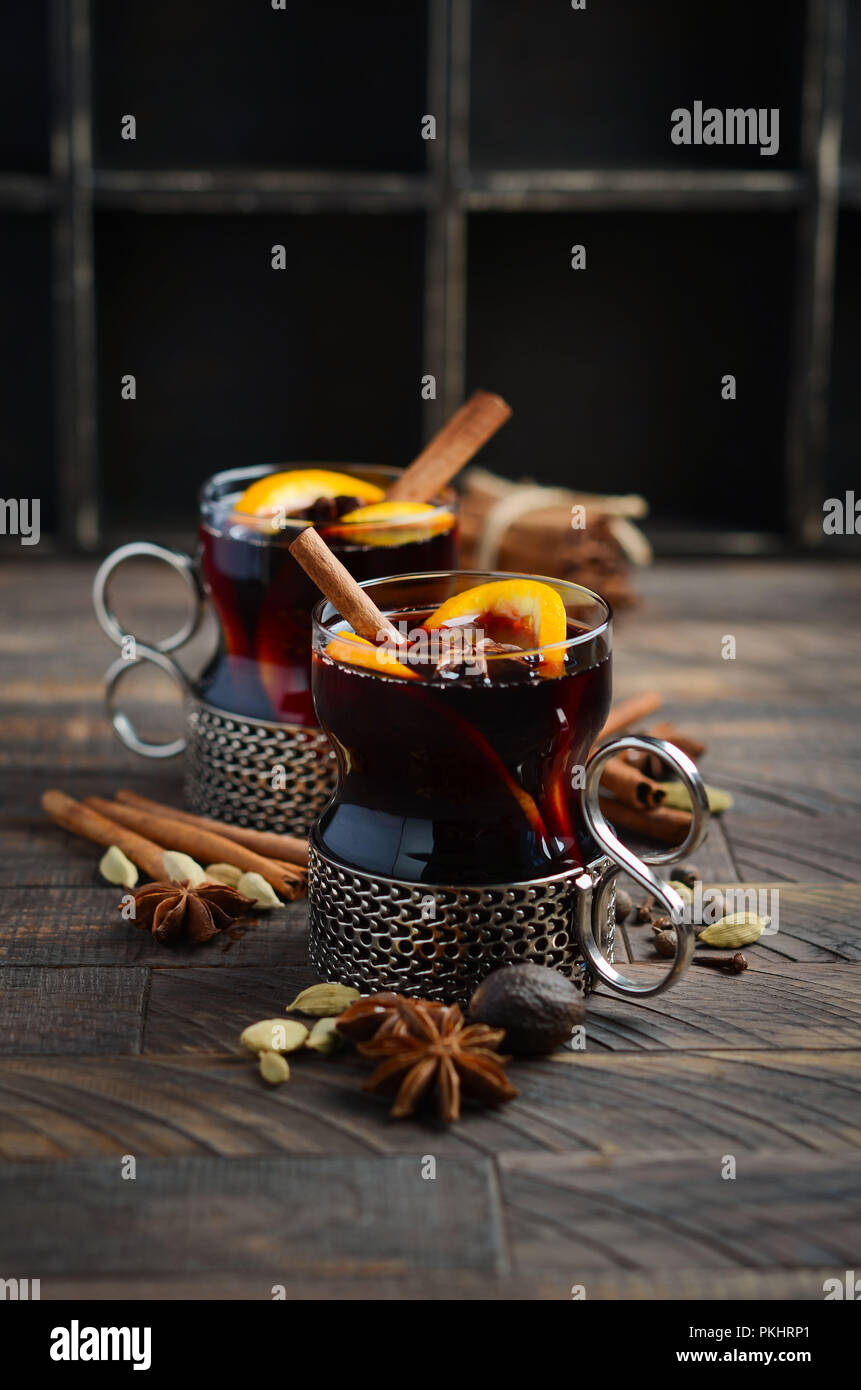 Mulled Wine with Oranges and Spices on the Old Wooden table. Stock Photo
