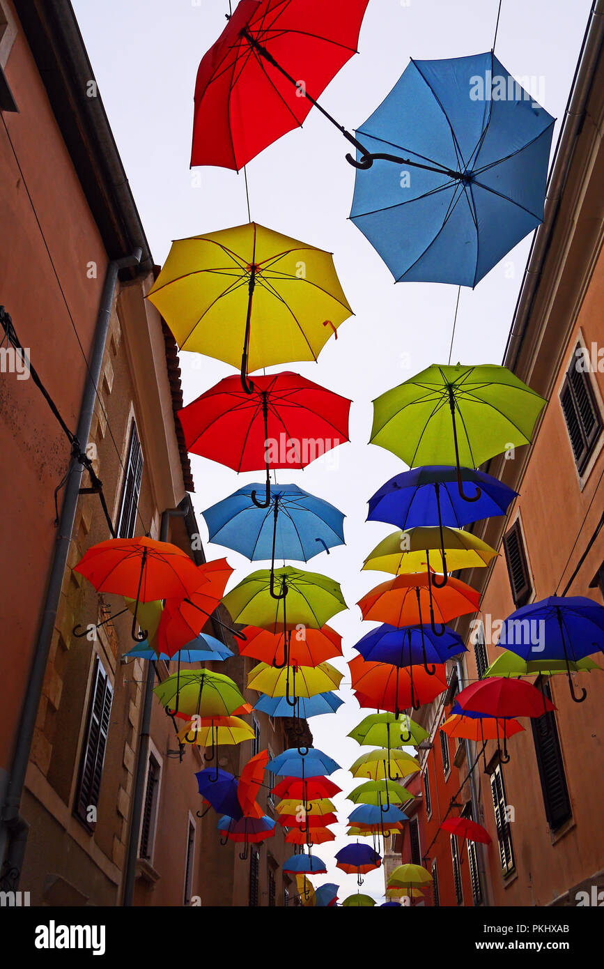 Umbrellas hanging in a street in Novigrad Stock Photo - Alamy