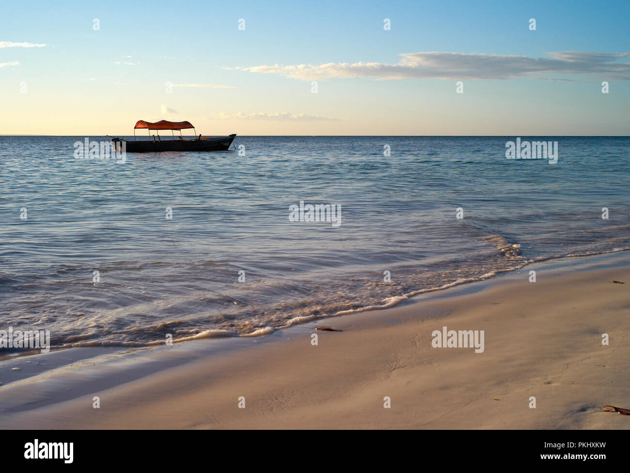 Beautiful Beach with  a Small Fishing Boat at Michamvi Beach, Zanzibar Stock Photo