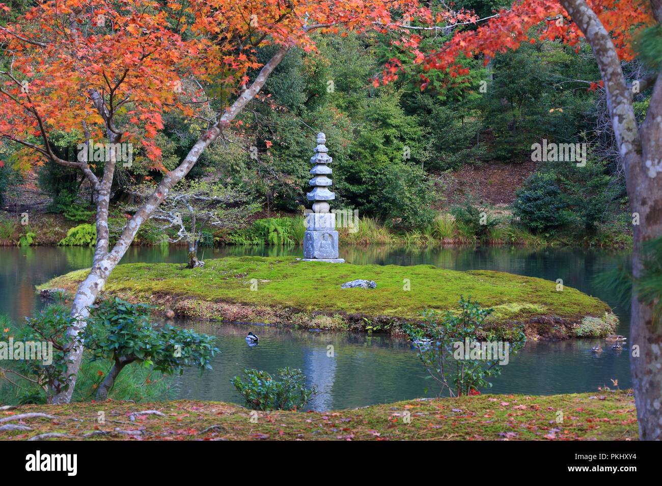 Kinkakuji Gardens in Kyoto, Japan. UNESCO World Heritage Site. Stone pagoda on a moss island. Stock Photo