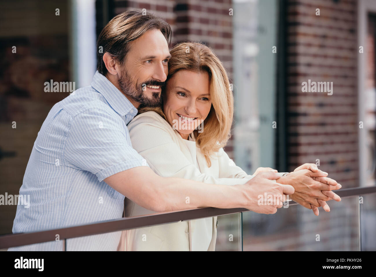 Couple hugging on balcony hi-res stock photography and images - Alamy