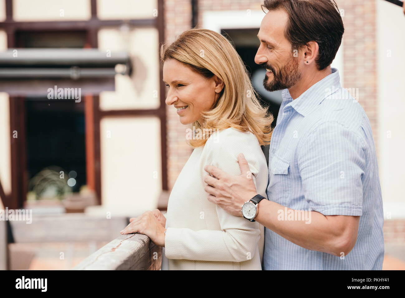 Couple hugging on bridge in hi-res stock photography and images - Alamy