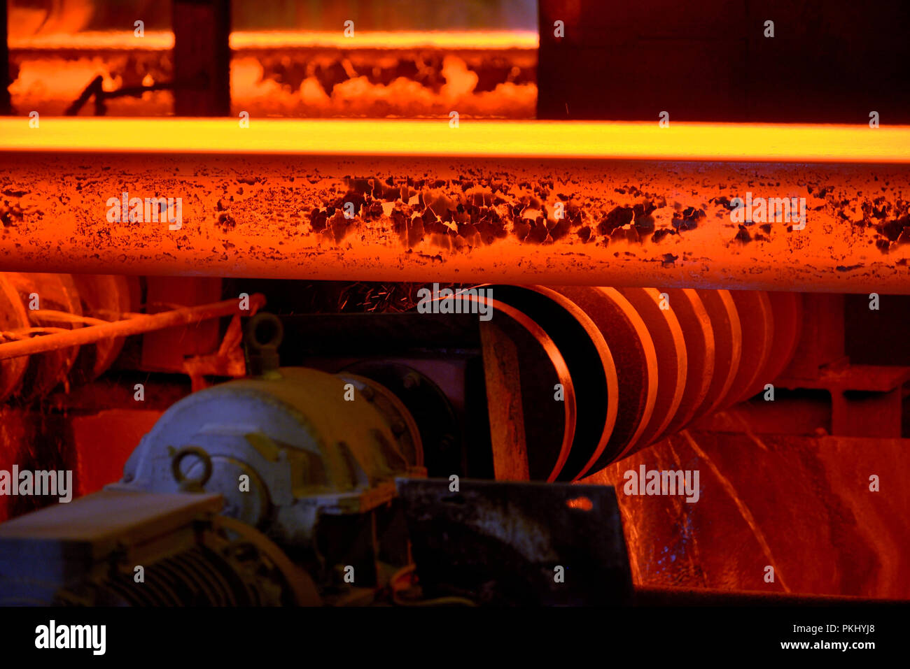 Hot steel plate on conveyor in steel plant Stock Photo