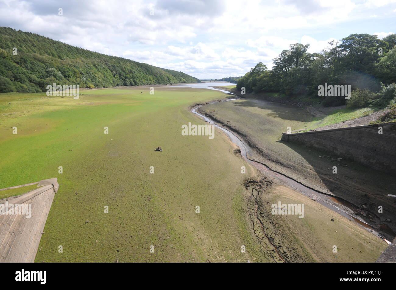 Leeds, Yorkshire UK. 13th Sept 2018. Water levels remain low at Lindley Reservoir in the Washubrn Valley, outside the Leeds/Bradford conurbations after a record hot summer. Lindley is just one of a string of reservoirs in the Washburn valley which feed water to major towns and cities in the area. credit David Hickes/Alamy Live News. Stock Photo