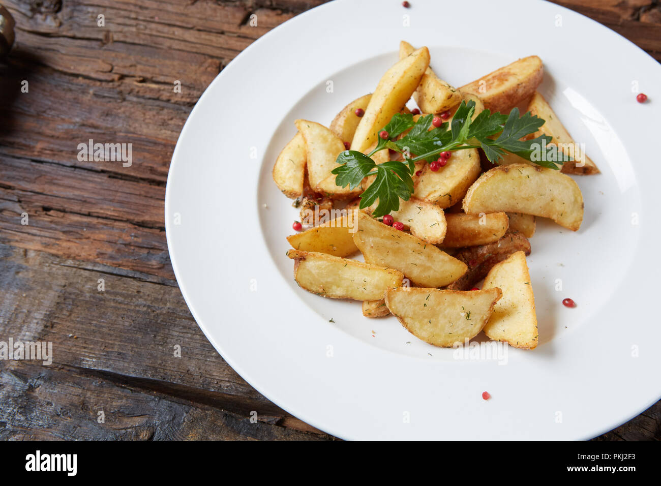 Homemade roasted potato with parsley on rustic background Stock Photo ...