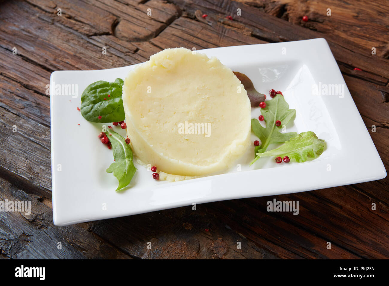 Potato Mash on rustic wooden background. Close-up shot Stock Photo