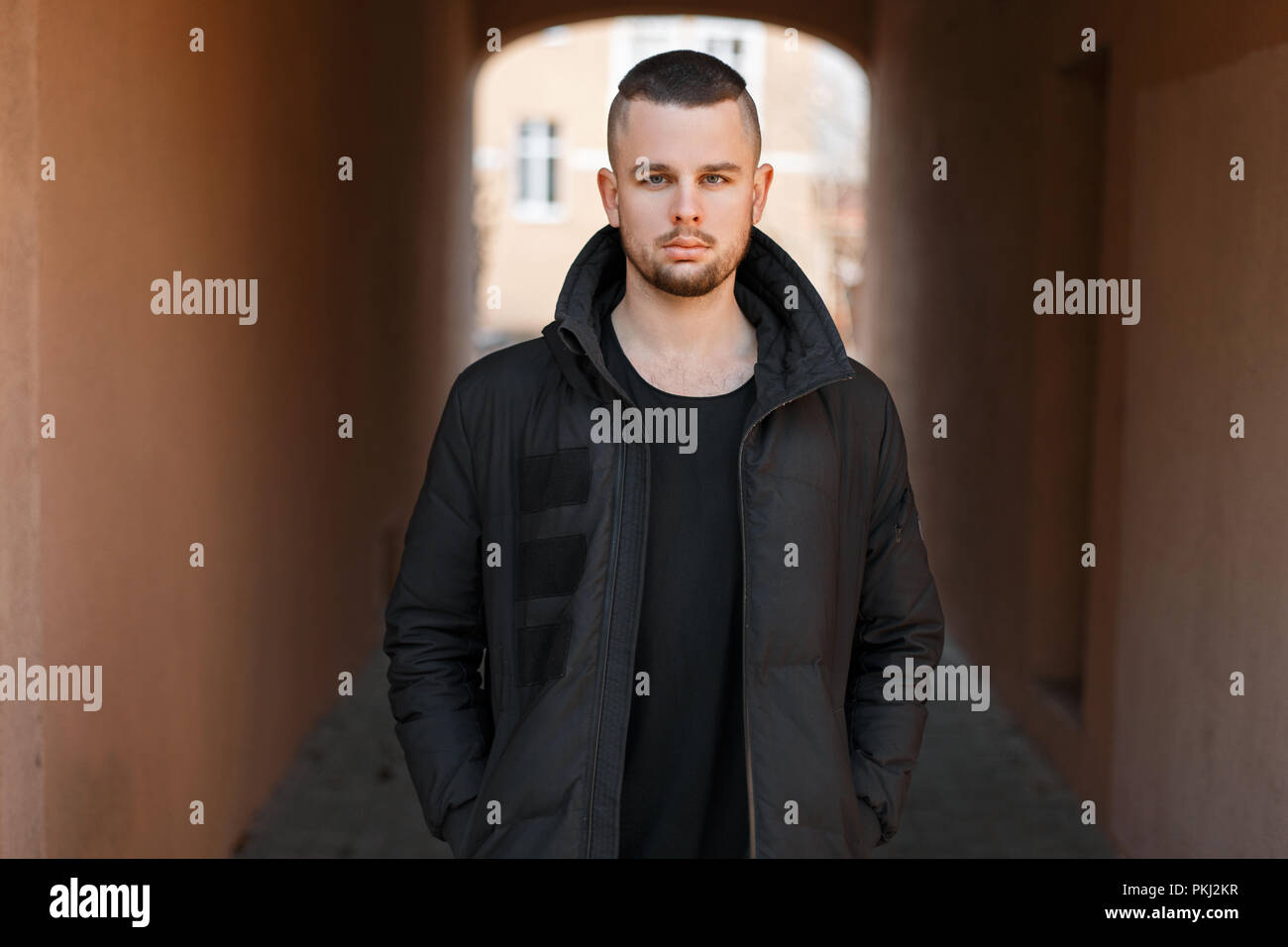 Stylish Young Handsome Man With A Short Haircut In A Black Fashion
