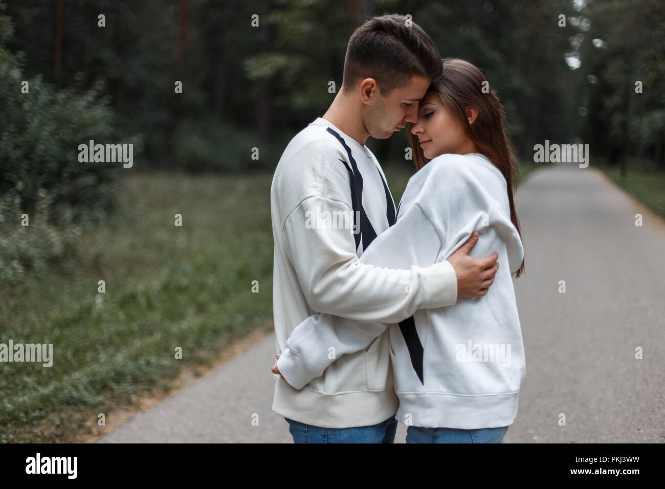 Young couple in love hug each other on the nature background Stock ...