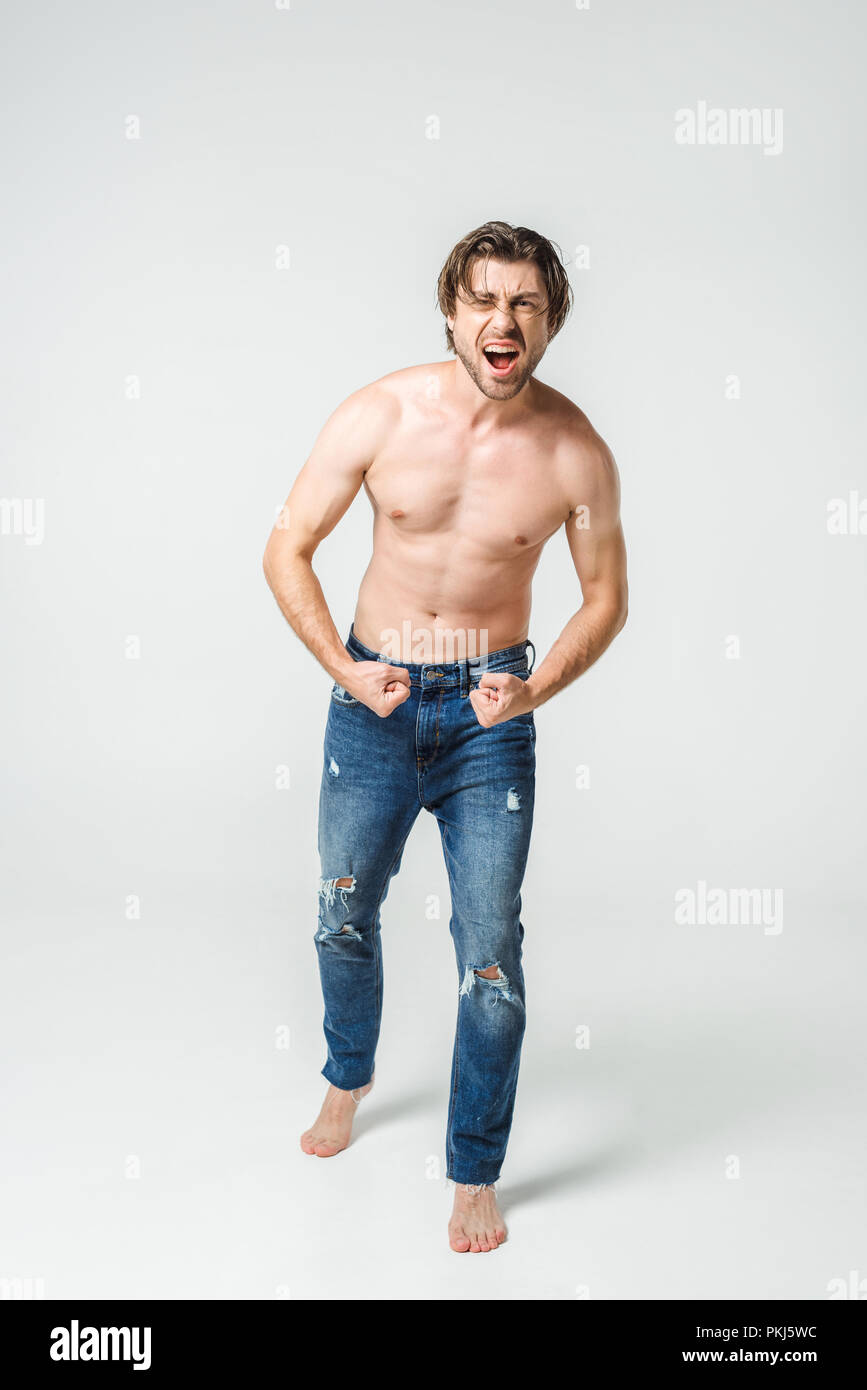 shirtless man in jeans