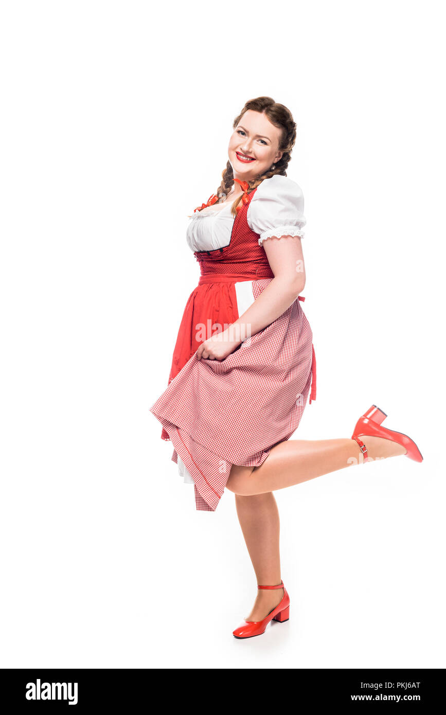 smiling oktoberfest waitress in traditional bavarian dress standing on one  leg isolated on white background Stock Photo - Alamy