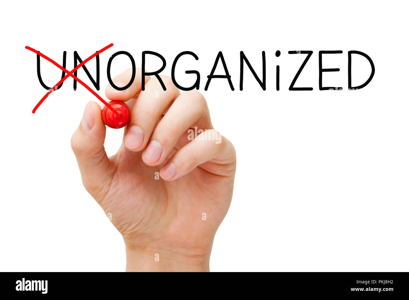 Hand changing the word Unorganized into Organized with red marker isolated on white. Stock Photo