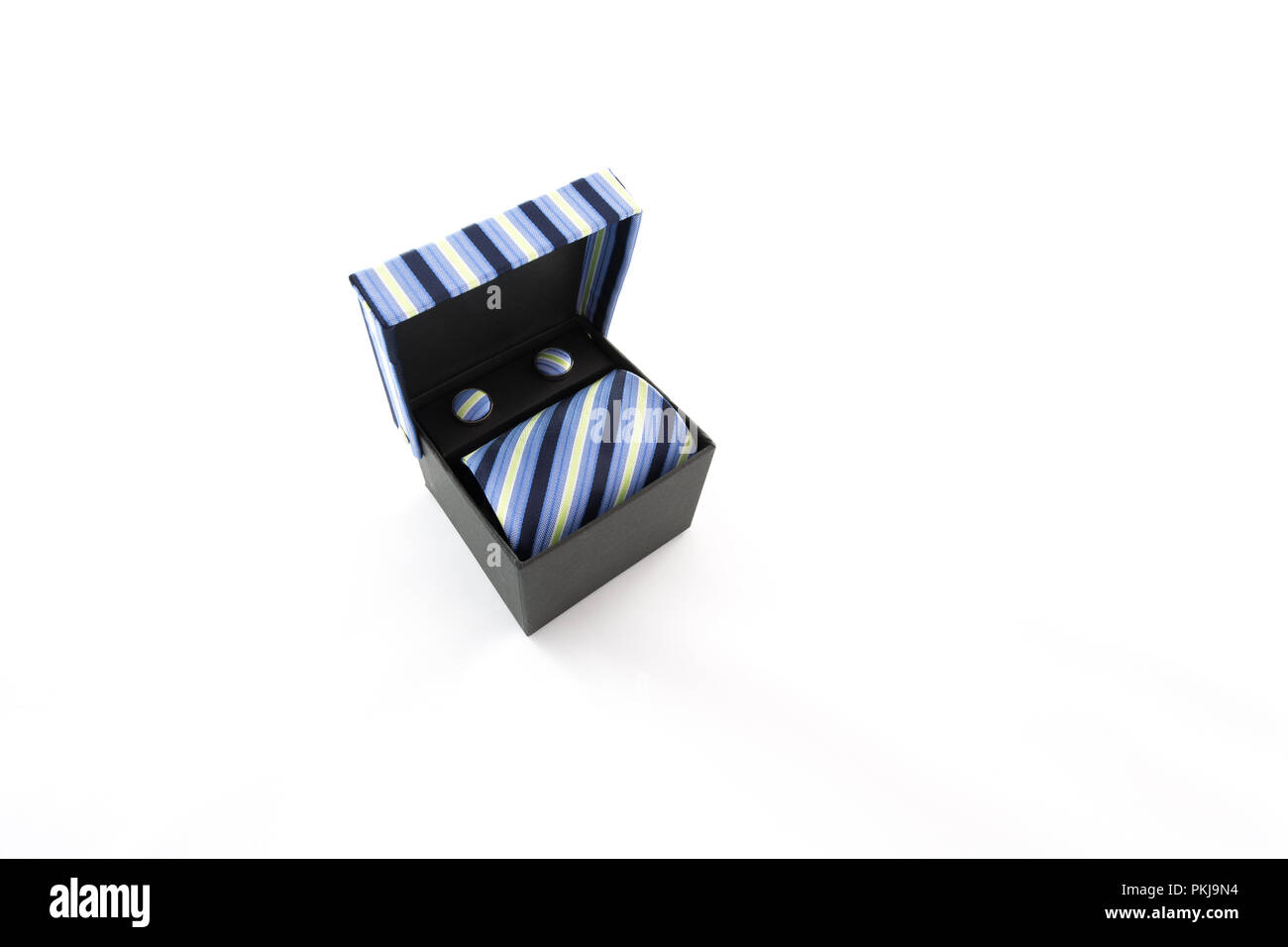 Neck tie and cuff link, blue and green seam geometric pattern, textured multicolor stripes fabric, set in the gift box, on white background Stock Photo