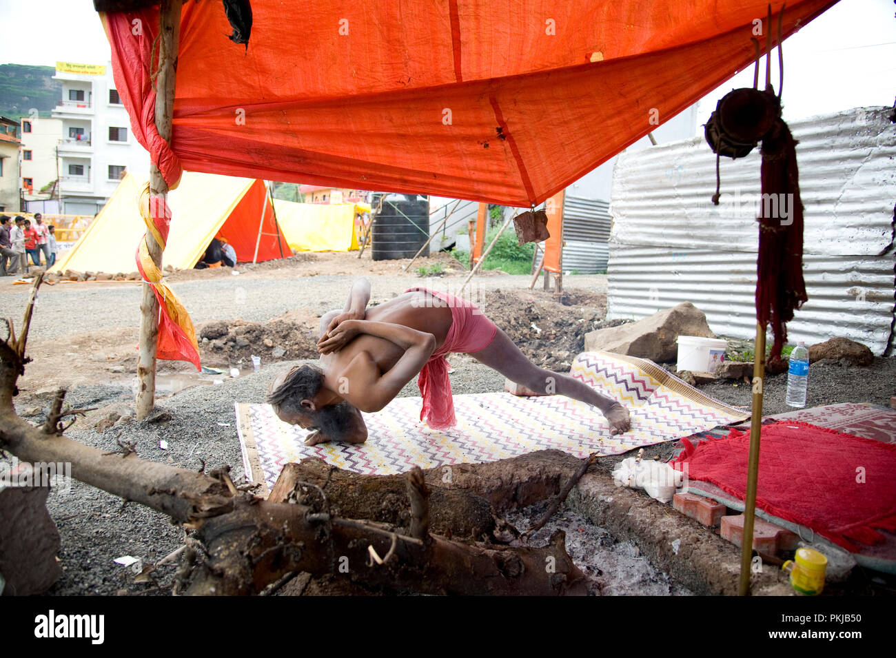 Naga baba sadhu doing yoga at nashik Kumbh Mela maharashtra India Stock Photo