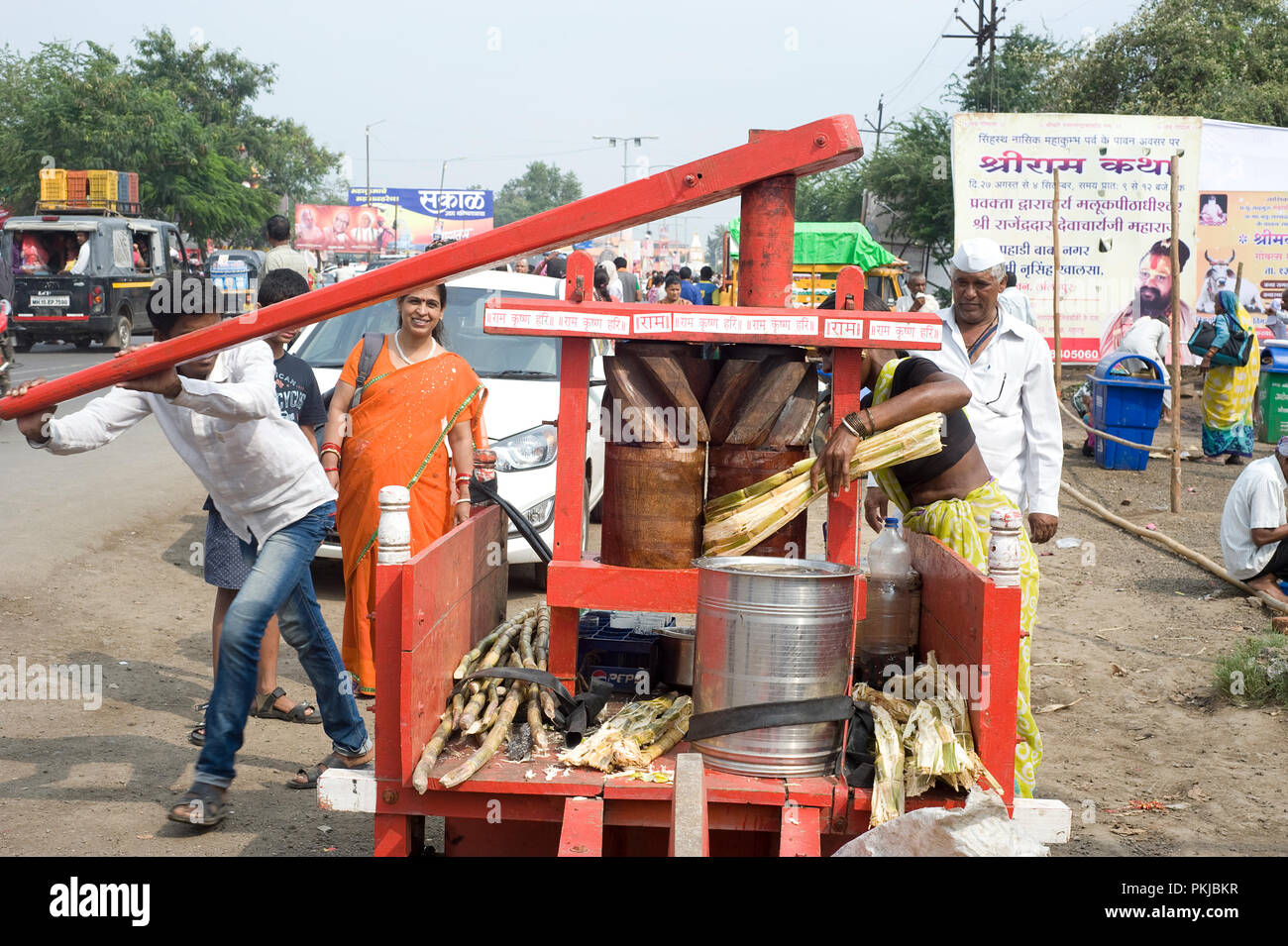 Local man making sugar cane juice drink with Traditional Handmade