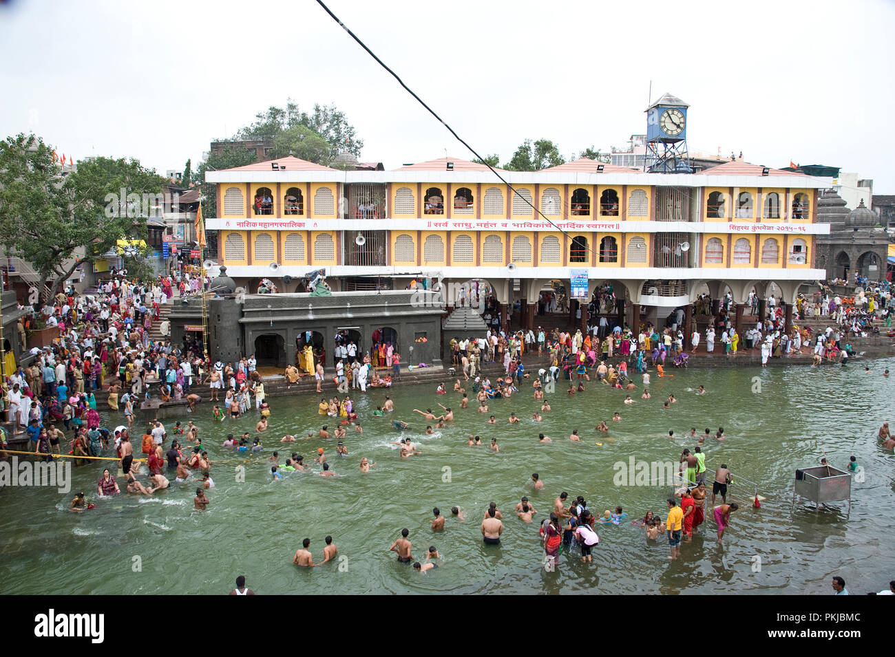 Crowd of Hindu devotees for taking Holy Dip in kumbha mela at nashik Panchavati  in godavari river maharashtra India Stock Photo