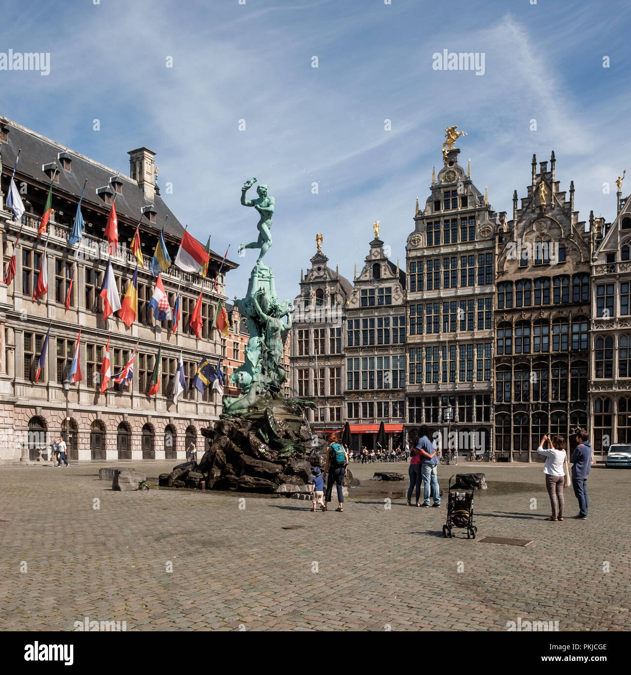 Tourists admiring the statue of Silvius Brabo on the main square of Antwerp, Friday 21 July 2017, Antwerp, Belgium. Stock Photo