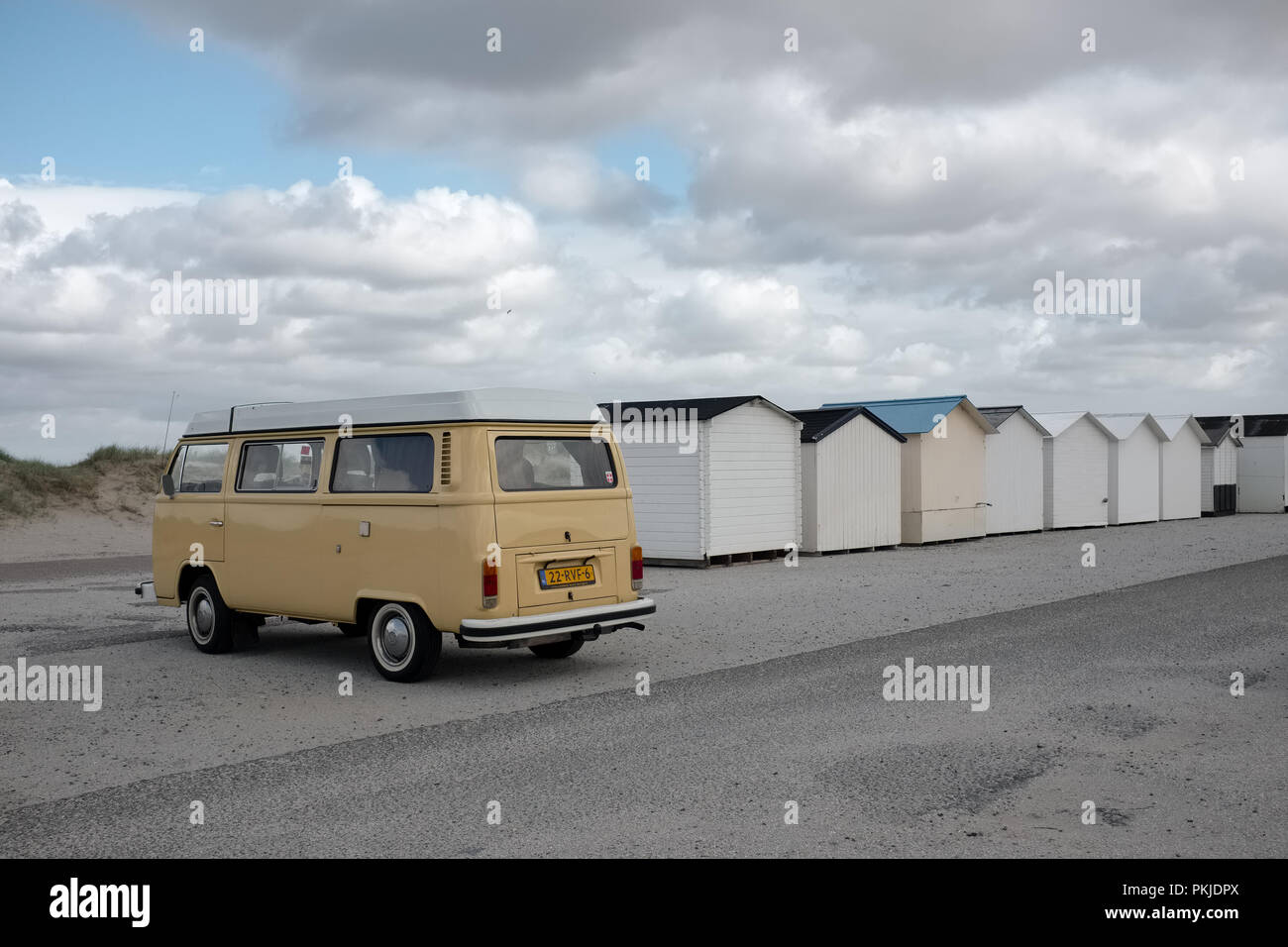 Old Volkswagen van and beach cabins on a deserted beach, Saturday 14 May 2016, Texel, the Netherlands. Stock Photo