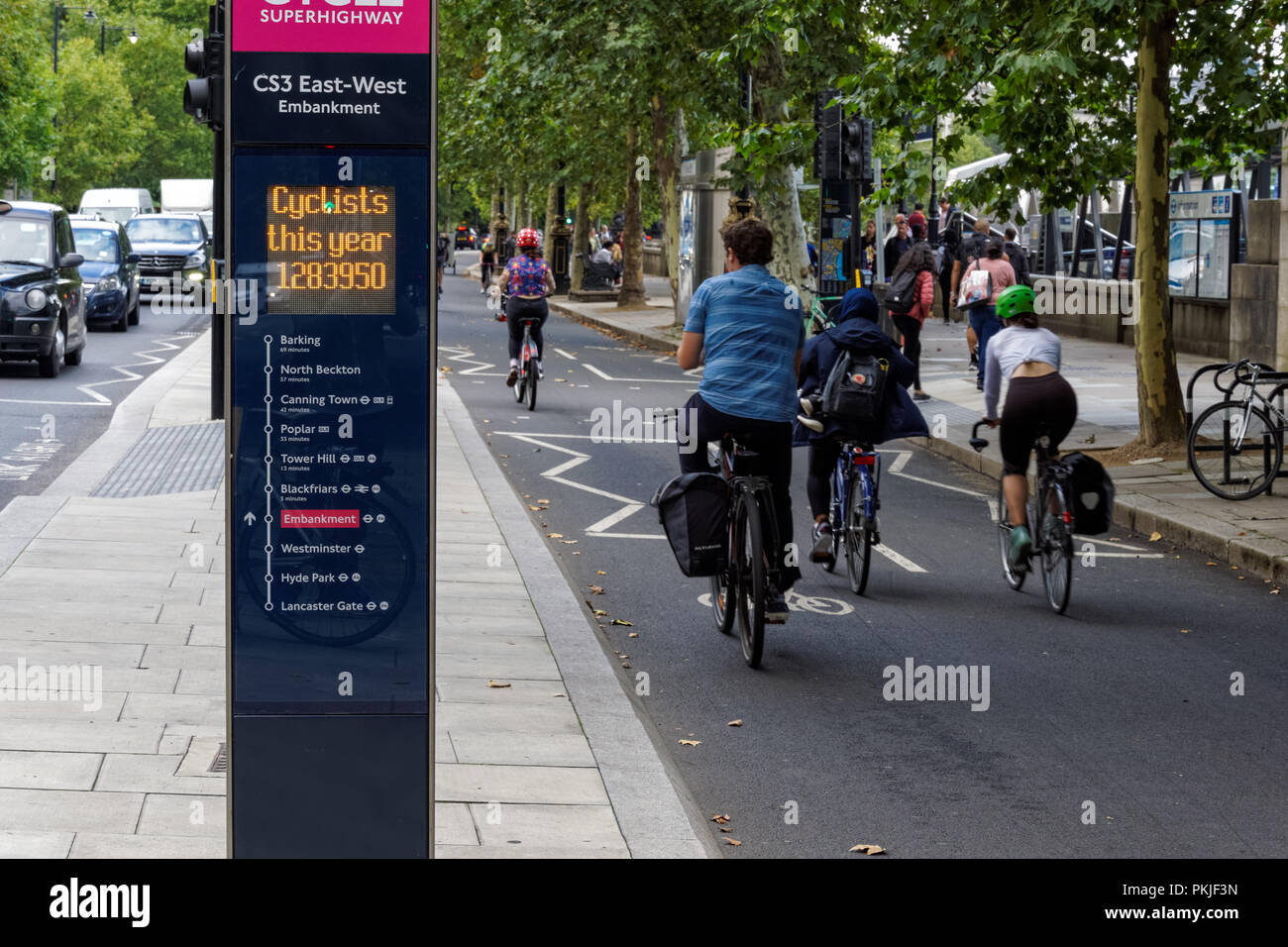 Cyclists passing Cycle Route CS3 Counter on Victoria Embankment, London England United Kingdom UK Stock Photo