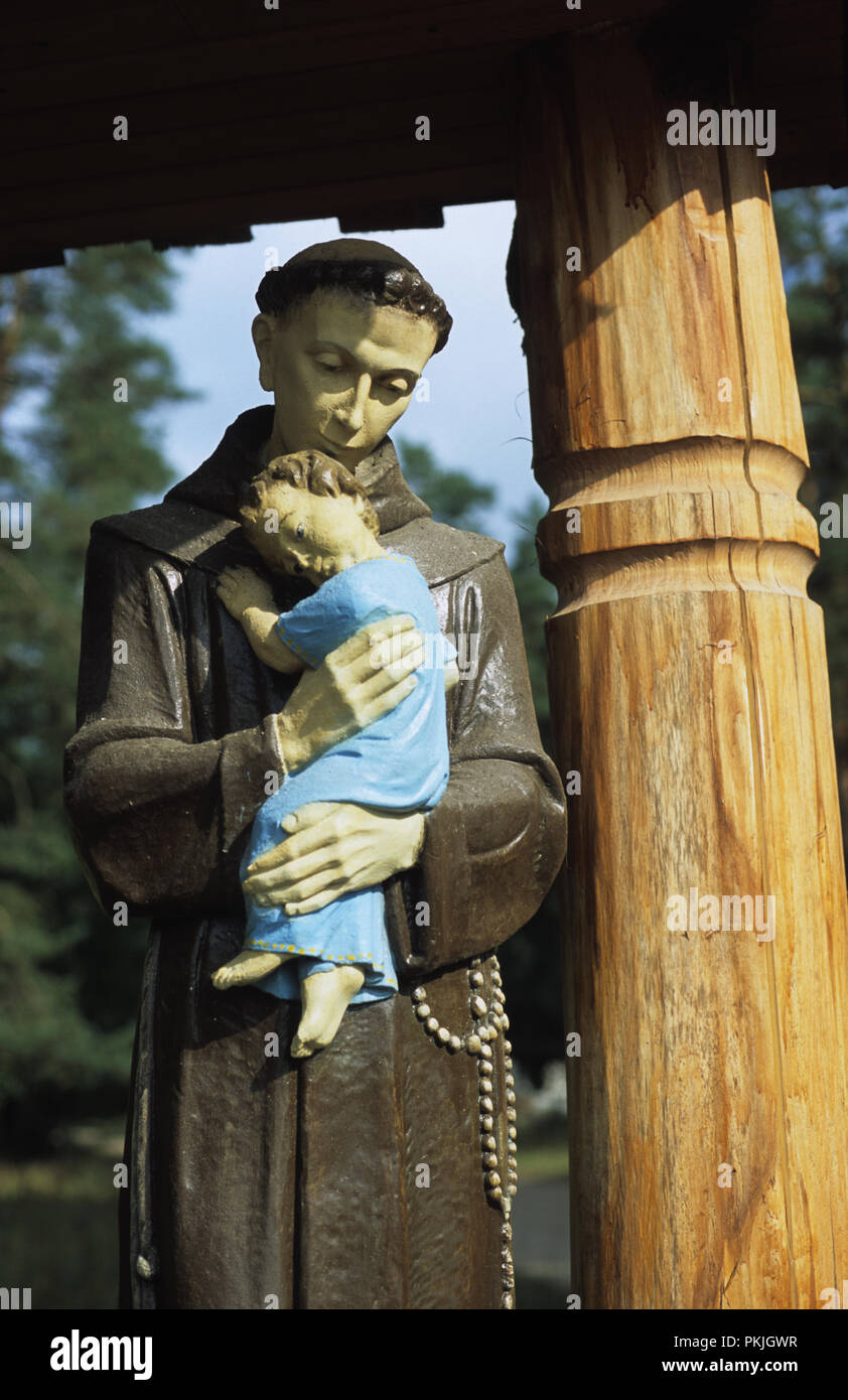 Statue of St Anthony of Padua hold the Jesus Child in village of Rudawka in the Augustowska forest in the Suwalszczyzna region of north east Poland Au Stock Photo