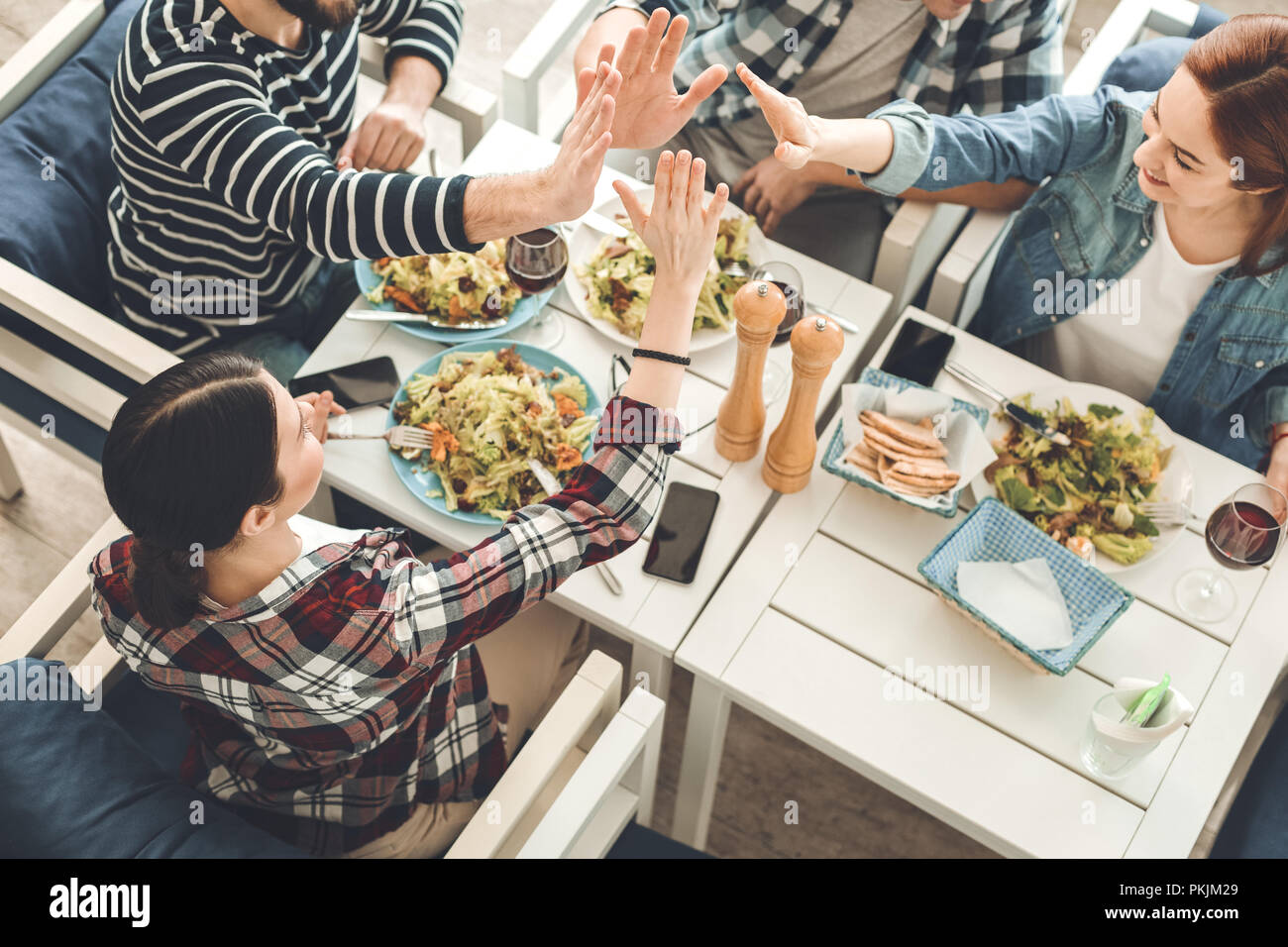 Delighted nice young people giving high five Stock Photo