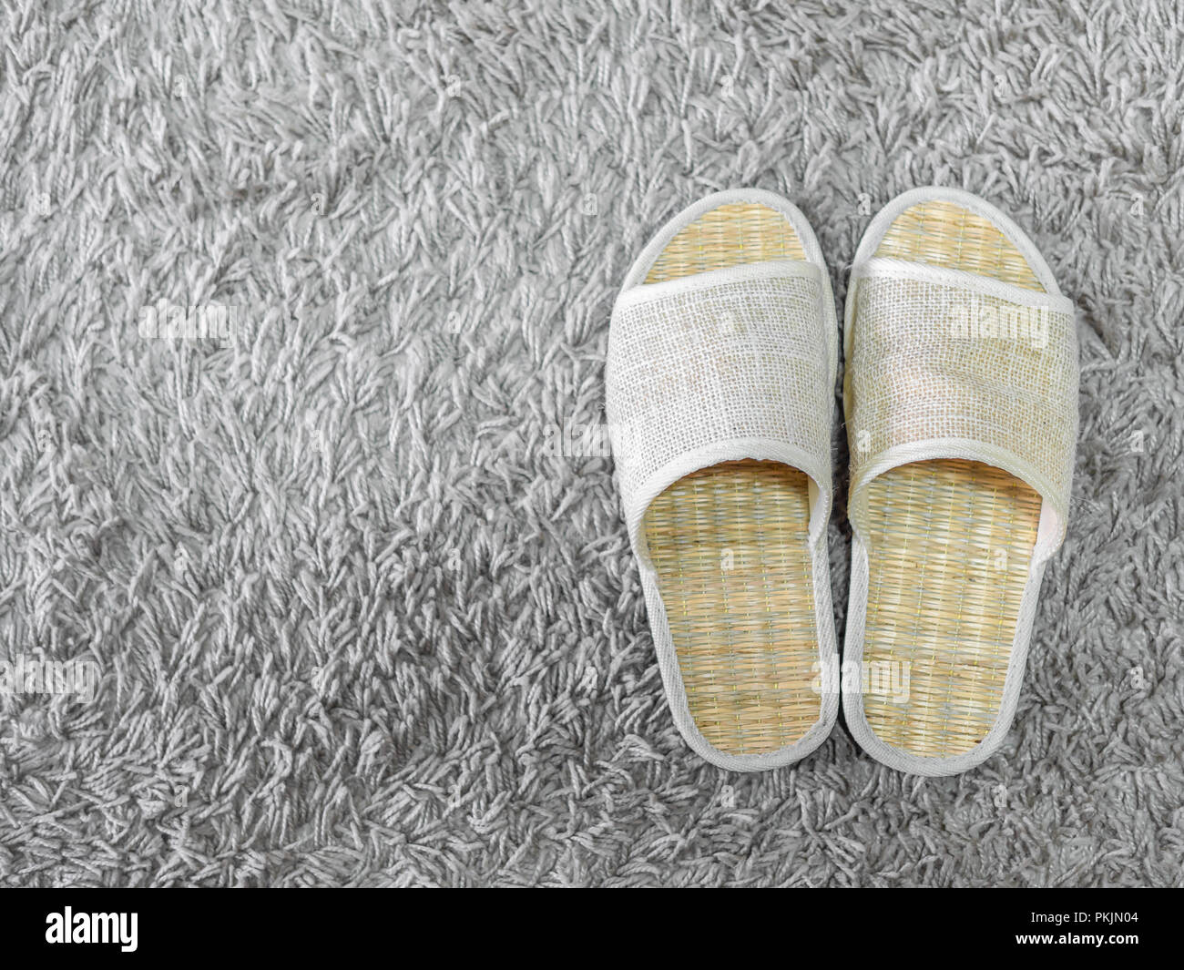 Weaving shoes on carpet. Weaving flip flops. Weaving slipper. Weaving sandal top view with space