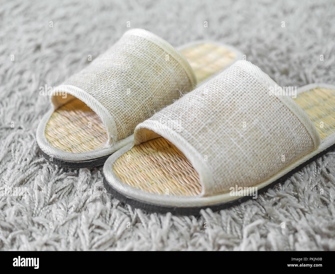 Close up weaving shoes on carpet. Weaving flip flops. Weaving sandal. Weaving slipper. Stock Photo