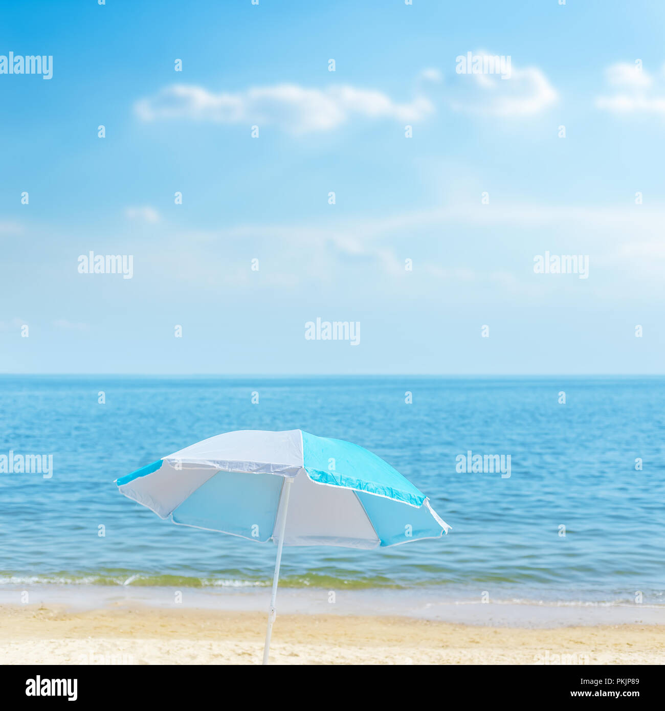 umbrella on the sea beach under blue sky with clouds. soft focus Stock ...