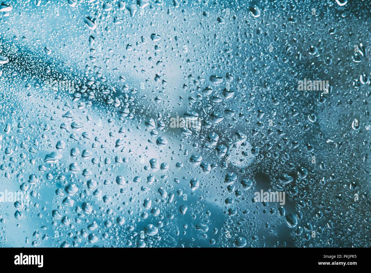 Water Drops Of Rain On Blue Glass Background. Close Up Stock Photo - Alamy