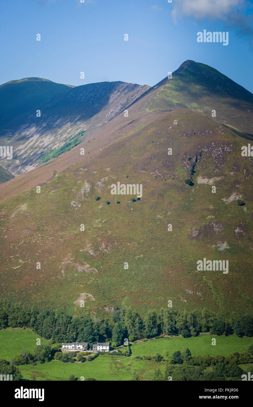 A white cottage nestles at the foot of Causey Pike, Newlands Valley, Lake District, UK. Stock Photo