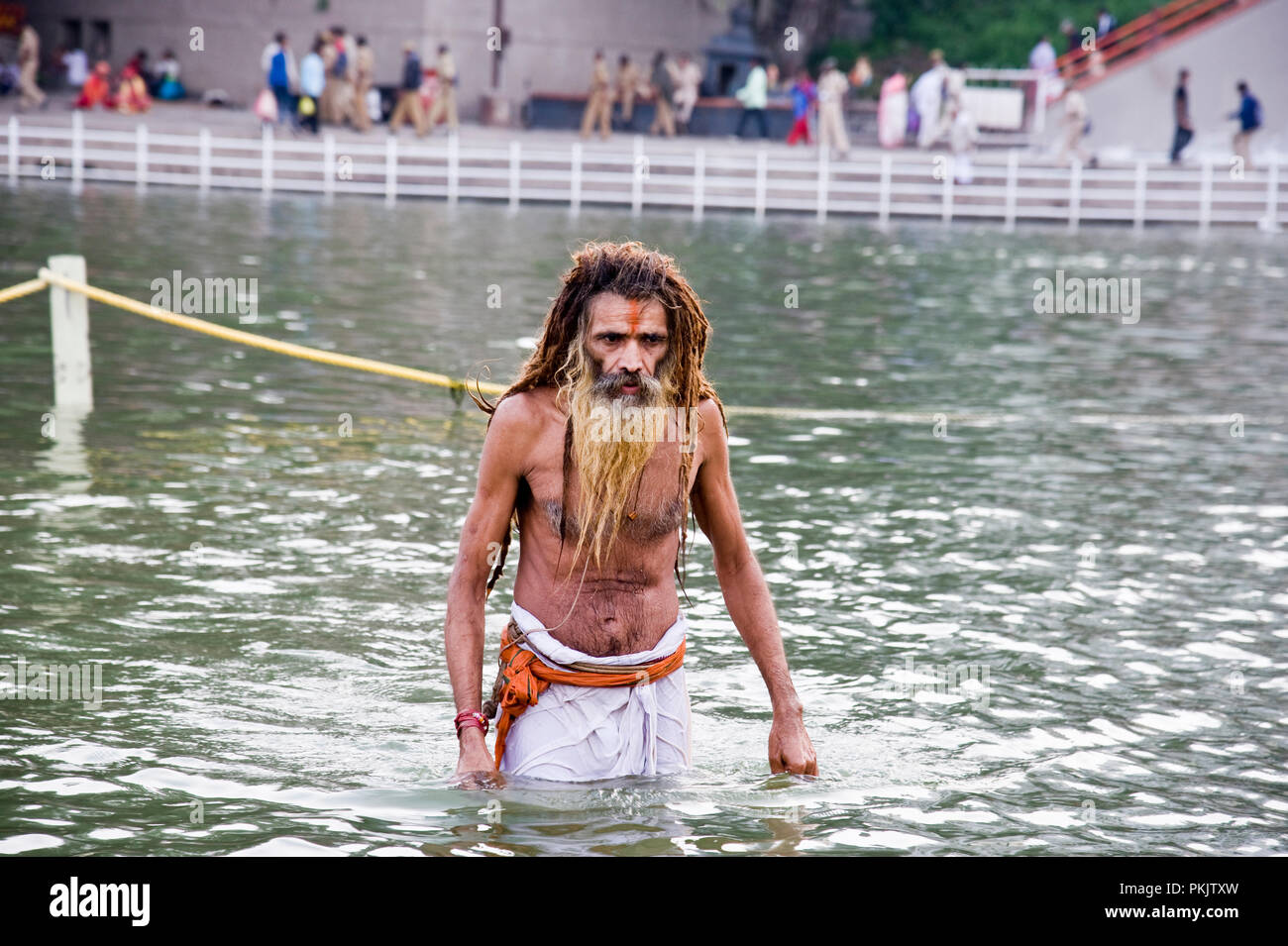 A Sadhu Hindu devotees Taking  Holy Dip at kumbha mela Panchavati ram kund  in godavari river nashik  maharashtra India Stock Photo