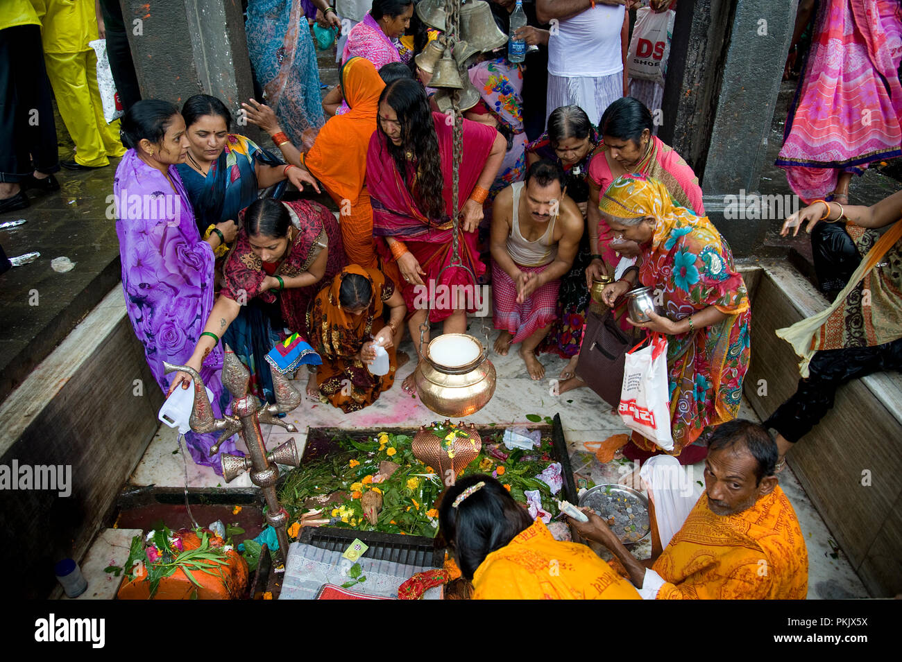 Hindu riligious women offers prayers by pouring milk or water or flower