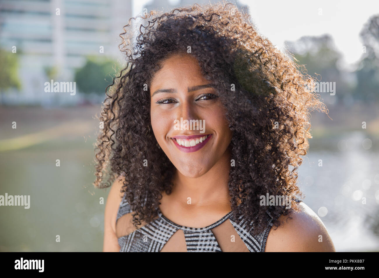Portrait of smiling young black woman Stock Photo - Alamy