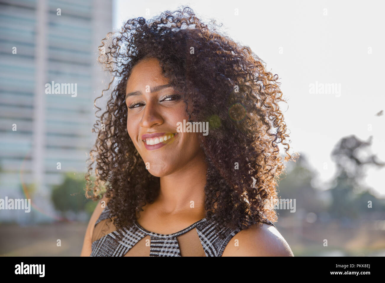 Portrait of smiling young black woman Stock Photo - Alamy